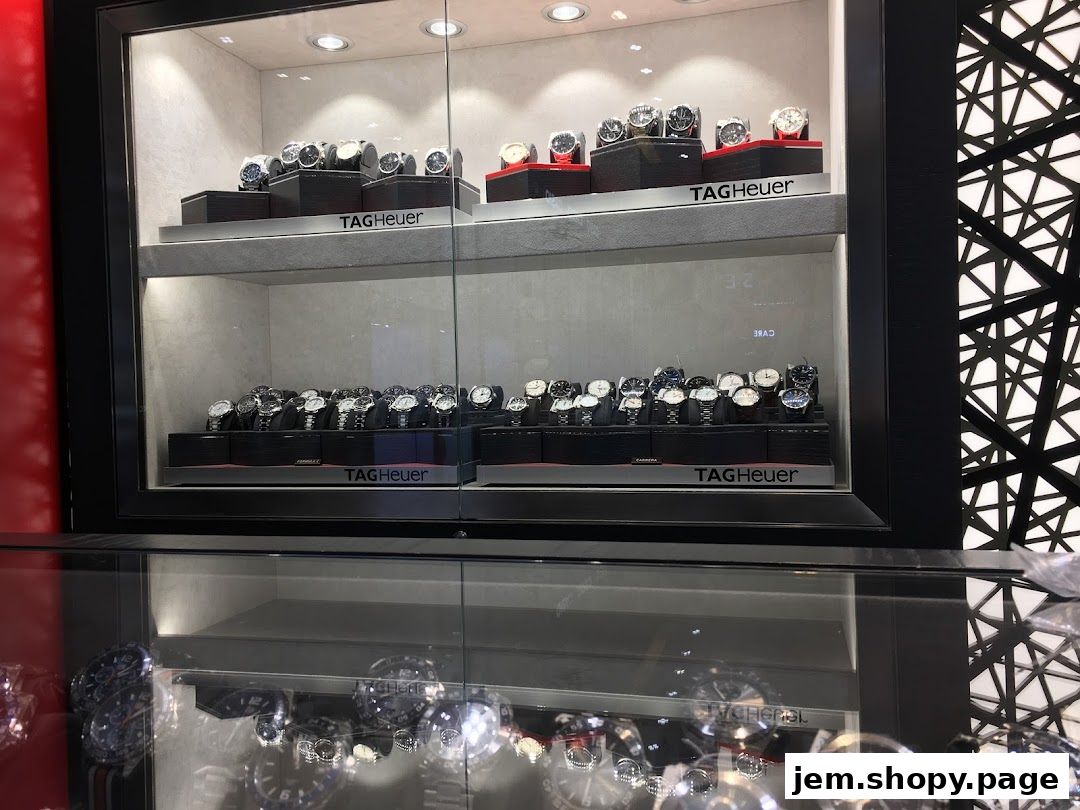 Display cases filled with luxury watches from brands like Tudor, TAG Heuer, and Longines.