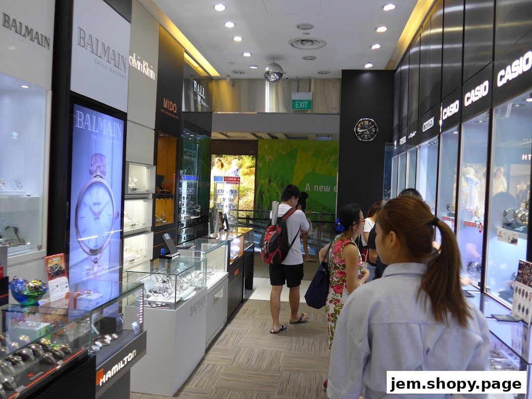 Interior view of a luxury watch retailer showcasing various brands and timepieces.