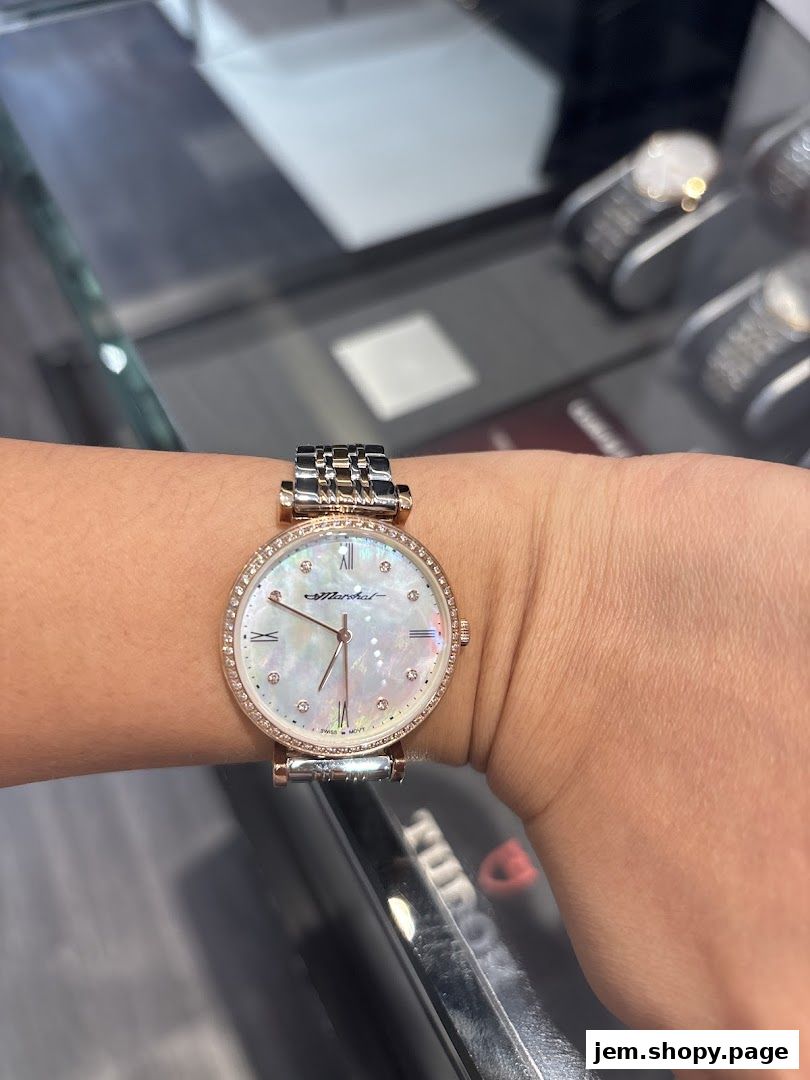 A close-up of a woman's wrist wearing a diamond-studded watch with a mother-of-pearl dial.