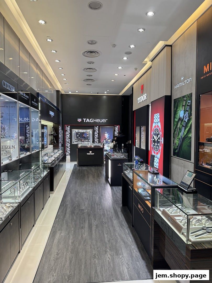 Interior view of a luxury watch retailer showcasing brands like Tudor, TAG Heuer, and Longines.