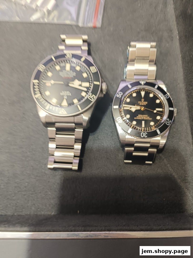Two luxury watches, Tudor and TAG Heuer, displayed on a dark surface.