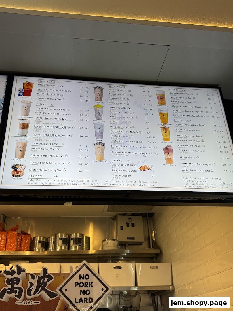 A digital menu board displaying various tea and dessert options with prices.