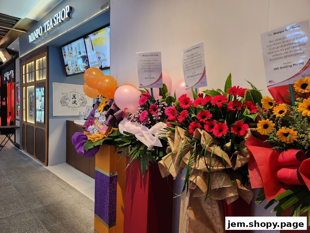 Wanpo Tea Shop storefront with congratulatory flower arrangements and balloons.