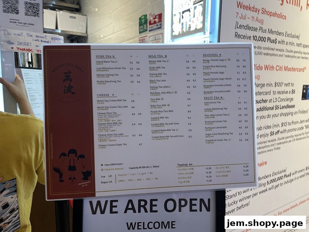 A menu board for Wanpo Tea Shop displaying various milk teas, fruit teas, and toppings.