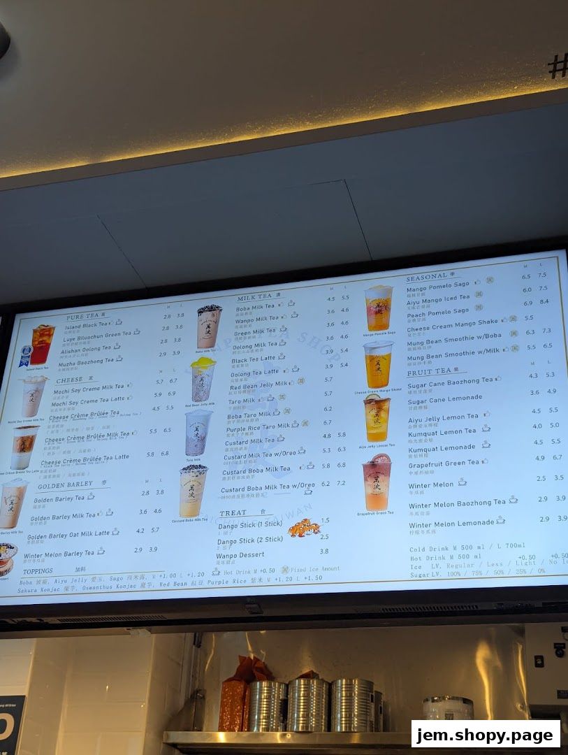 A digital menu board displaying various tea and dessert options with prices.