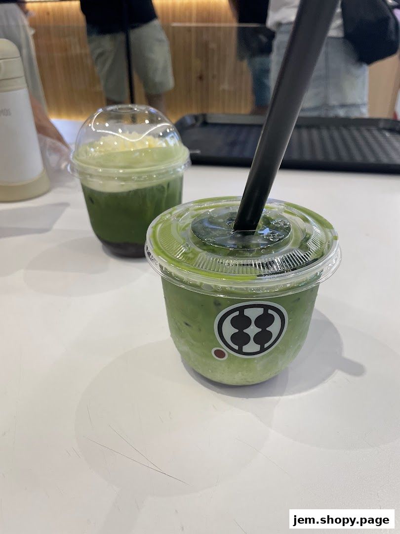 Two refreshing matcha drinks with whipped cream and red bean paste.