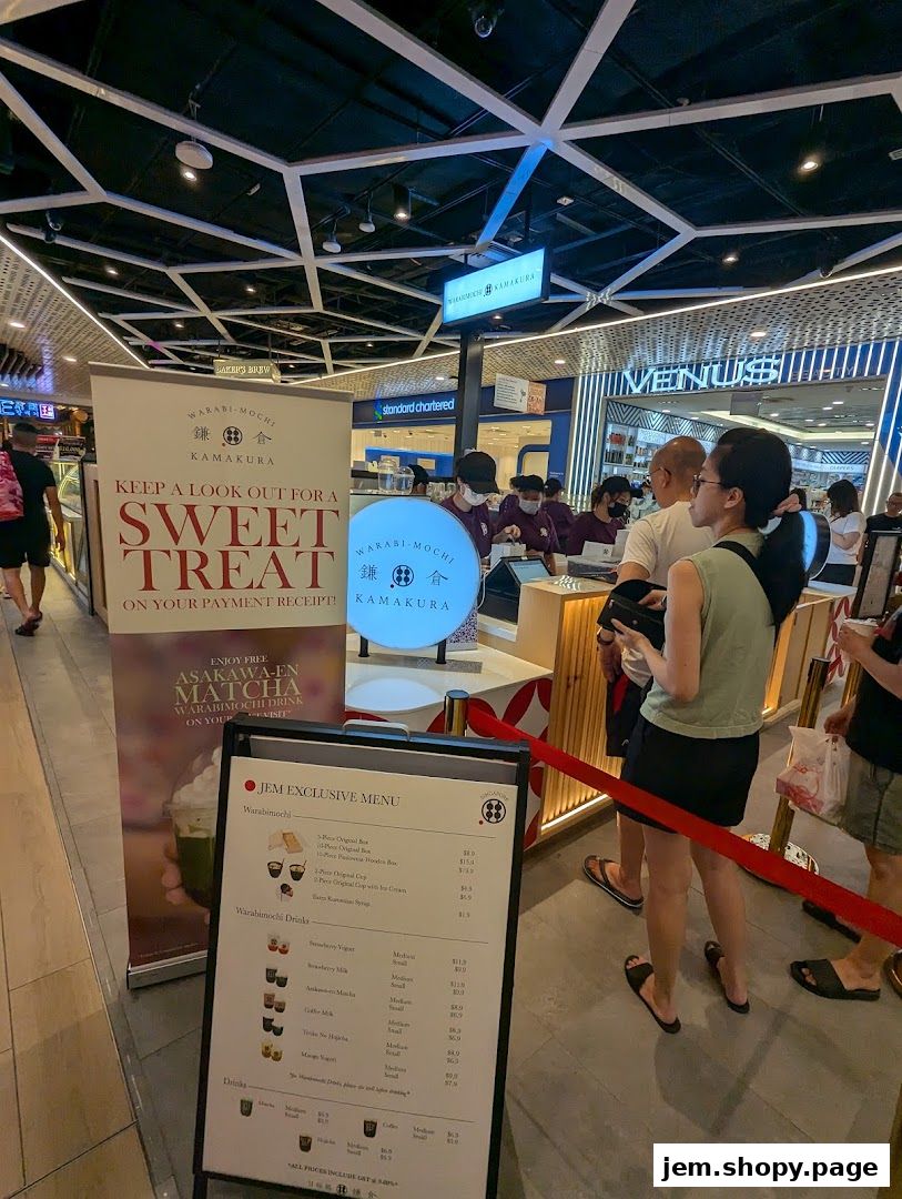 A menu board for Warabimochi Kamakura displays sweet treats and drinks.