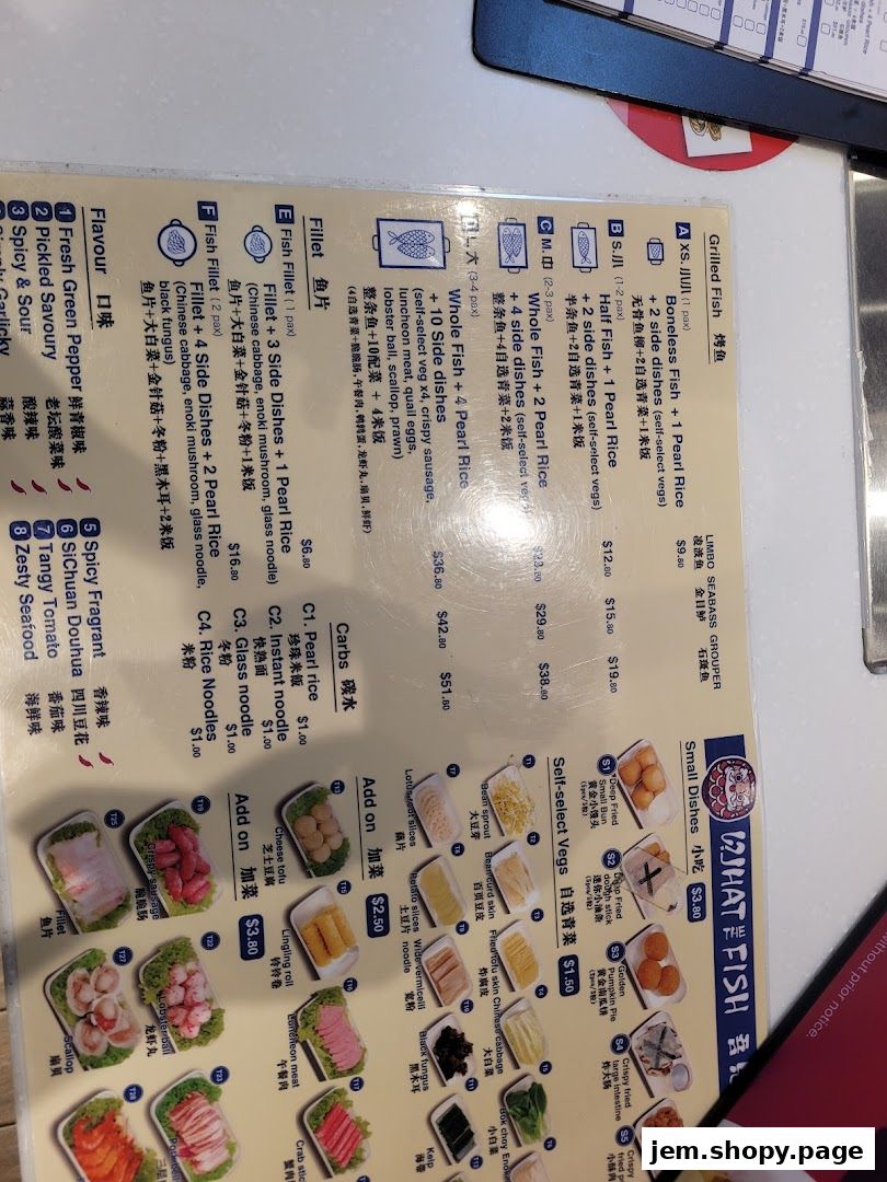 A menu for 'What The Fish' restaurant featuring grilled fish, side dishes, and carbs.