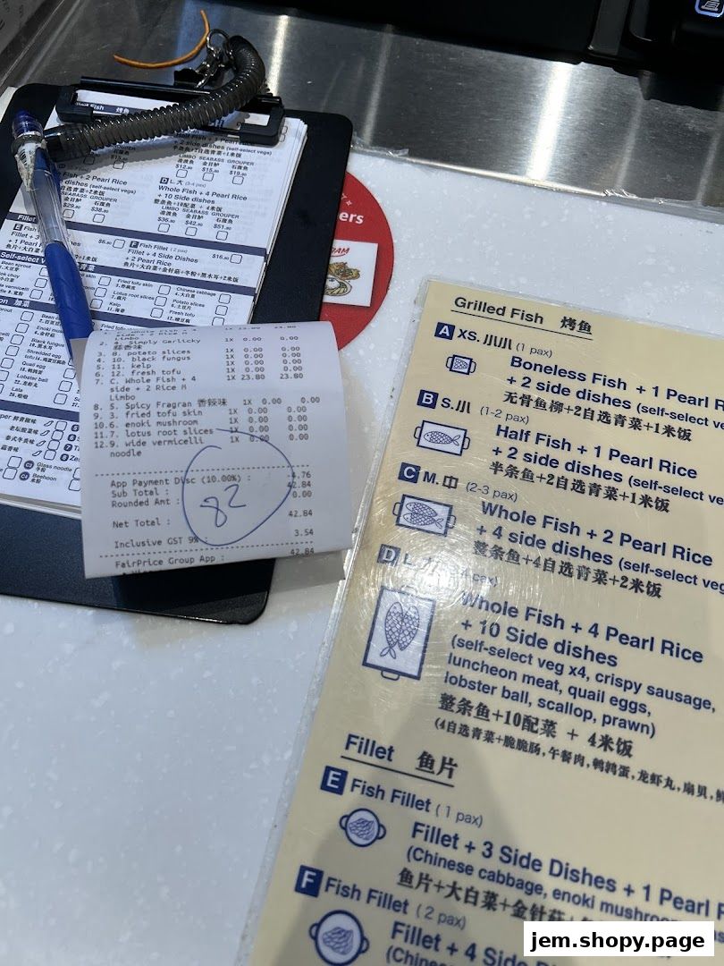 A close-up of a menu and receipt from a seafood restaurant, showing grilled fish options.