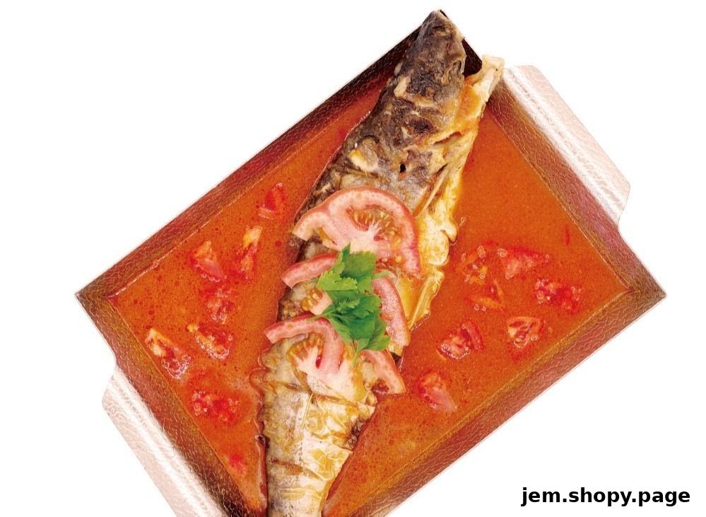 A whole fish dish in a rich, orange sauce with tomatoes and cilantro.