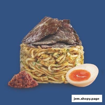 A dish of noodles topped with meat and served with a side of chili paste and a halved egg.