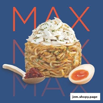 A tall stack of noodles topped with crab meat, served with a spoonful of chili paste and a halved egg.