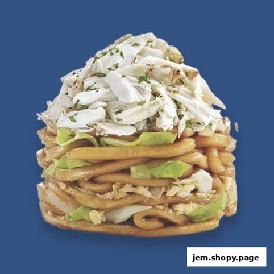 A tall stack of noodles topped with shredded chicken and lettuce.