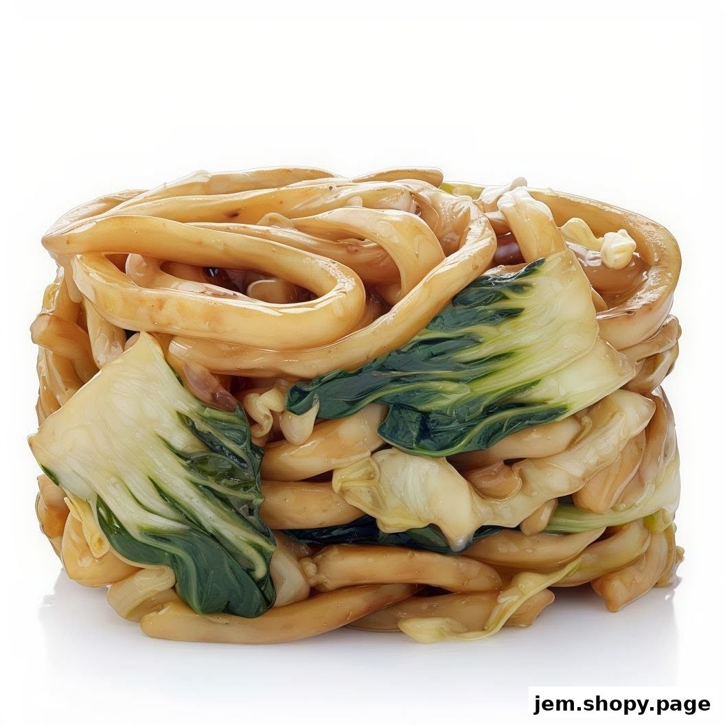 A close-up shot of a delicious stir-fried noodle dish with bok choy and sauce.