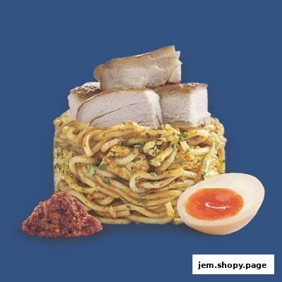 A serving of noodles topped with pork belly and a side of chili paste and a soft-boiled egg.