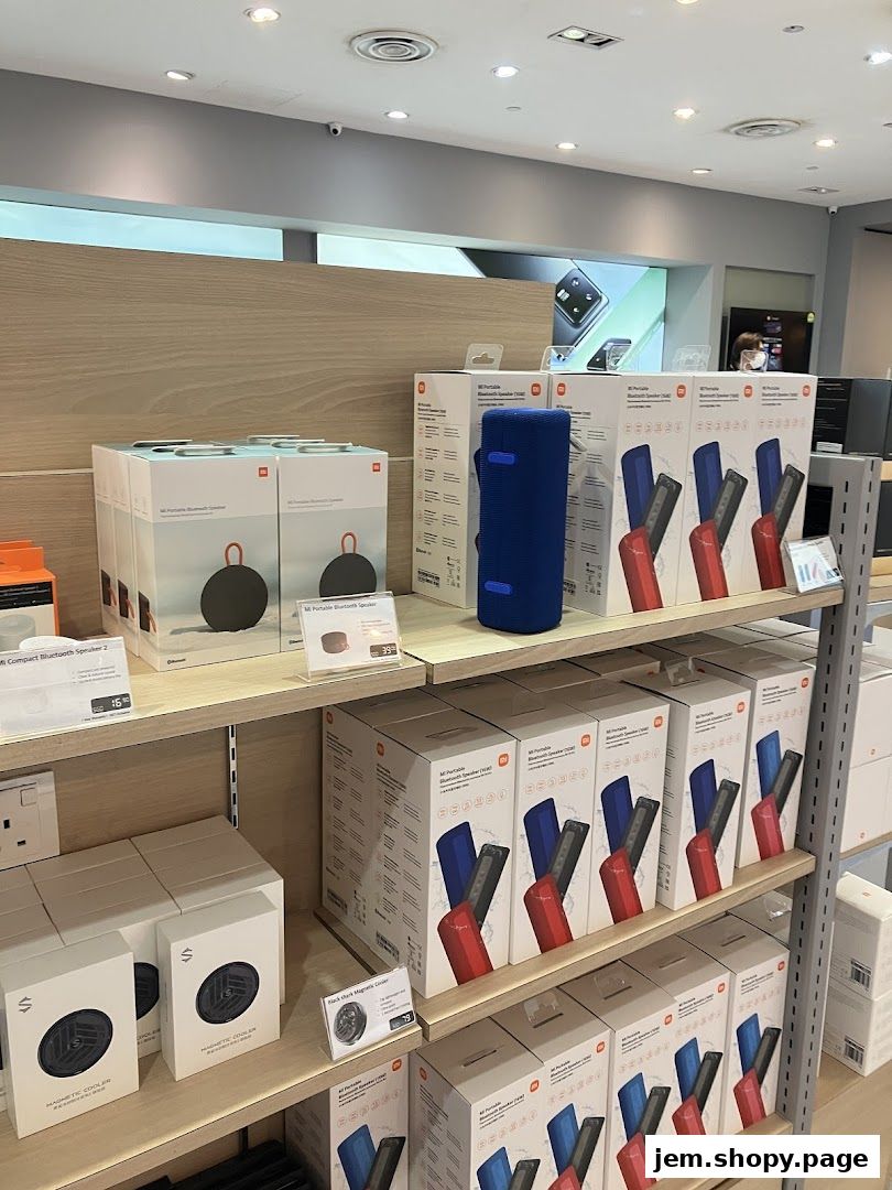 Shelves stocked with Xiaomi portable Bluetooth speakers and other accessories in a retail store.