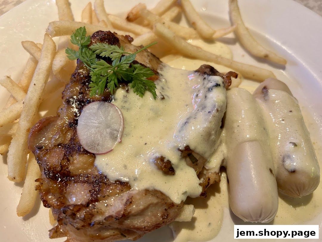 A close-up of a grilled chicken dish with fries and sausages, drizzled in sauce.