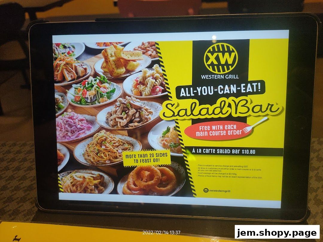 A tablet displaying an advertisement for XW Western Grill's All-You-Can-Eat Salad Bar.