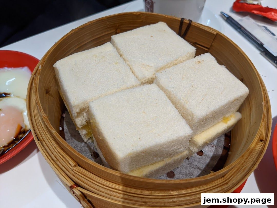 A close-up of Ya Kun Kaya Toast's signature kaya toast served in a bamboo steamer.