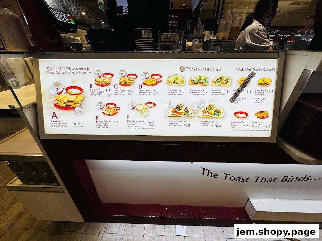 A menu board displaying value set meals, toastwiches, and all-day sides at Ya Kun Kaya Toast.