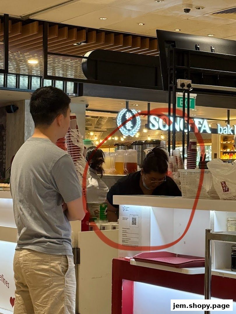 Customers interact with staff at a food stall with visible branding.