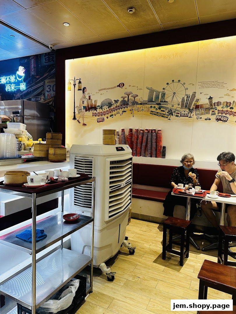 Interior of Ya Kun Kaya Toast with customers dining and a decorative mural.