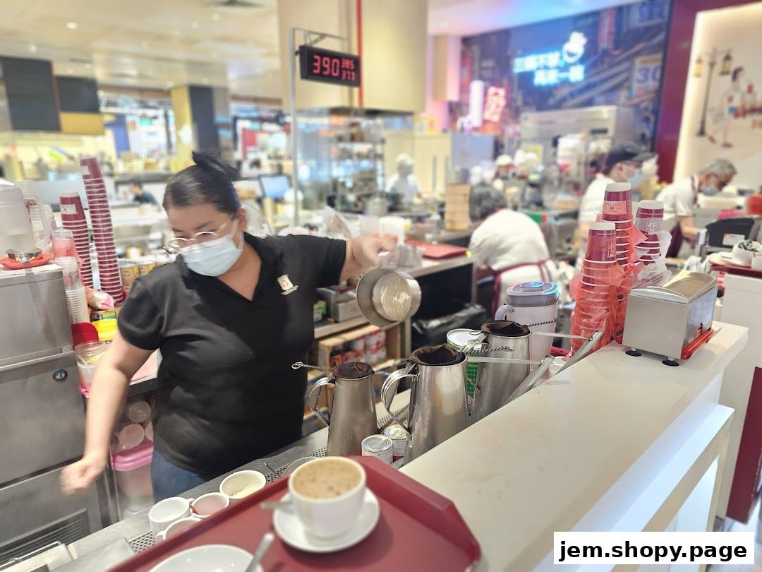A barista prepares drinks behind the counter at Ya Kun Kaya Toast.