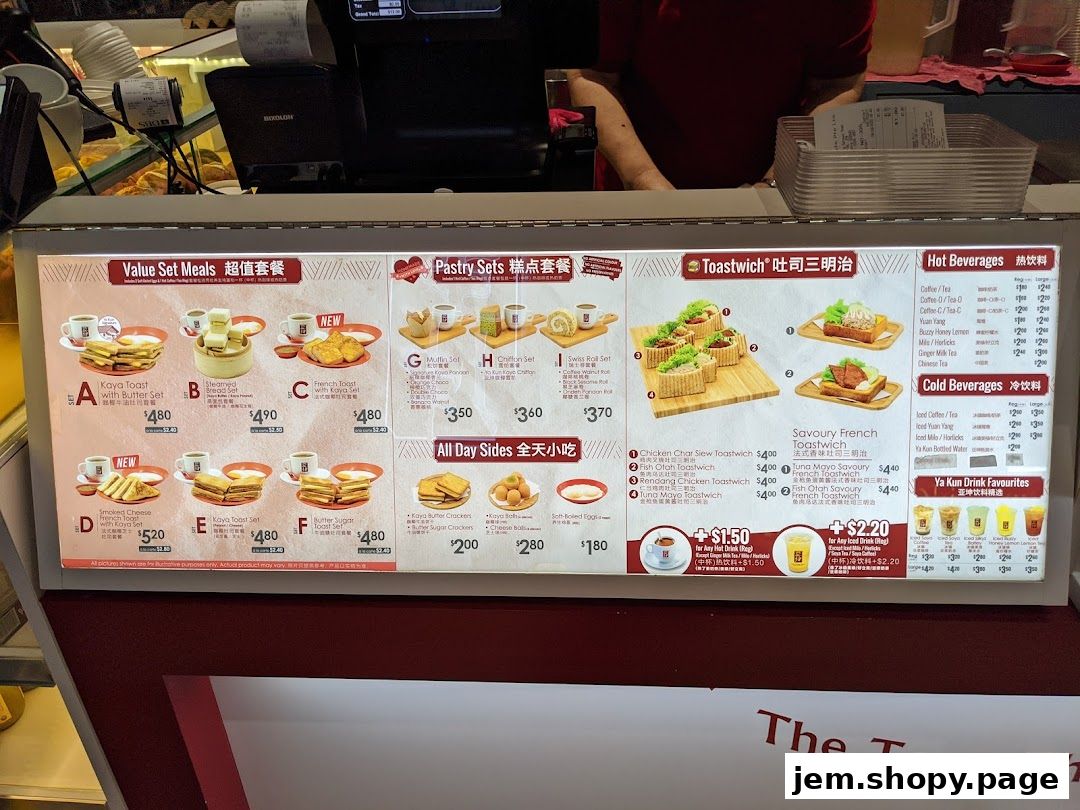 A menu board displaying various set meals, pastries, toastwiches, and beverages from Ya Kun Kaya Toast.