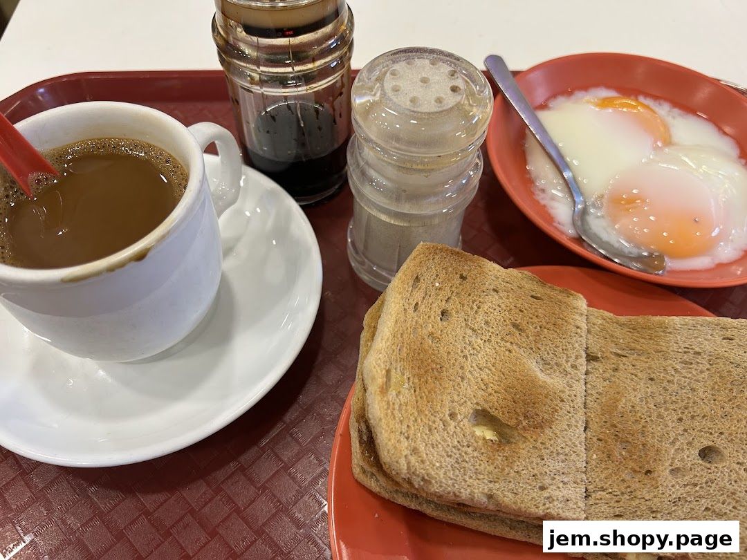 A close-up of a traditional breakfast set with coffee, toast, and soft-boiled eggs.