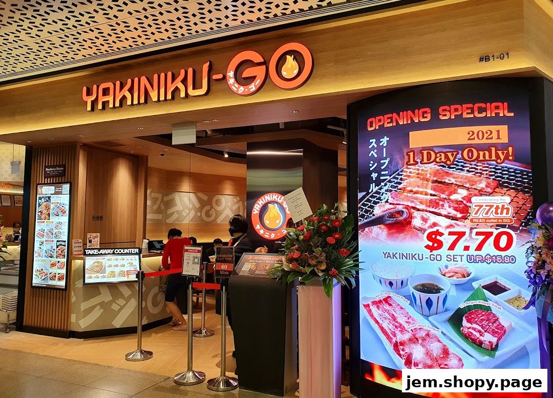 The entrance of Yakiniku-GO restaurant with a digital display showing an opening special offer.