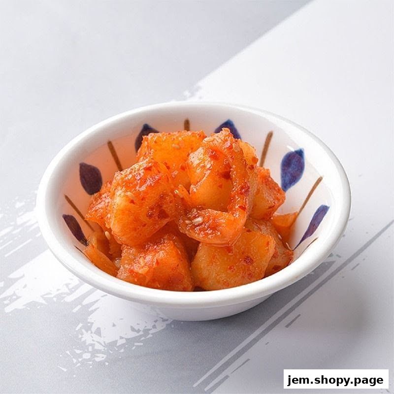 A small white bowl filled with Korean radish kimchi, seasoned with chili flakes.
