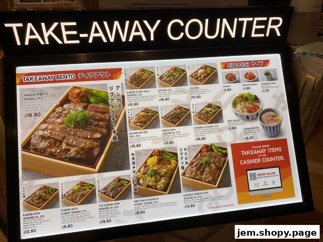 A menu board displaying various Japanese yakiniku bento boxes and side dishes for takeaway.