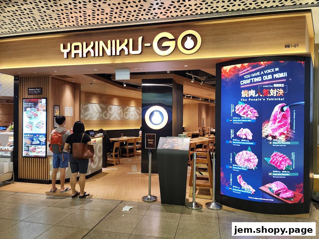 The entrance of Yakiniku-GO restaurant with a digital menu displaying various meat cuts.