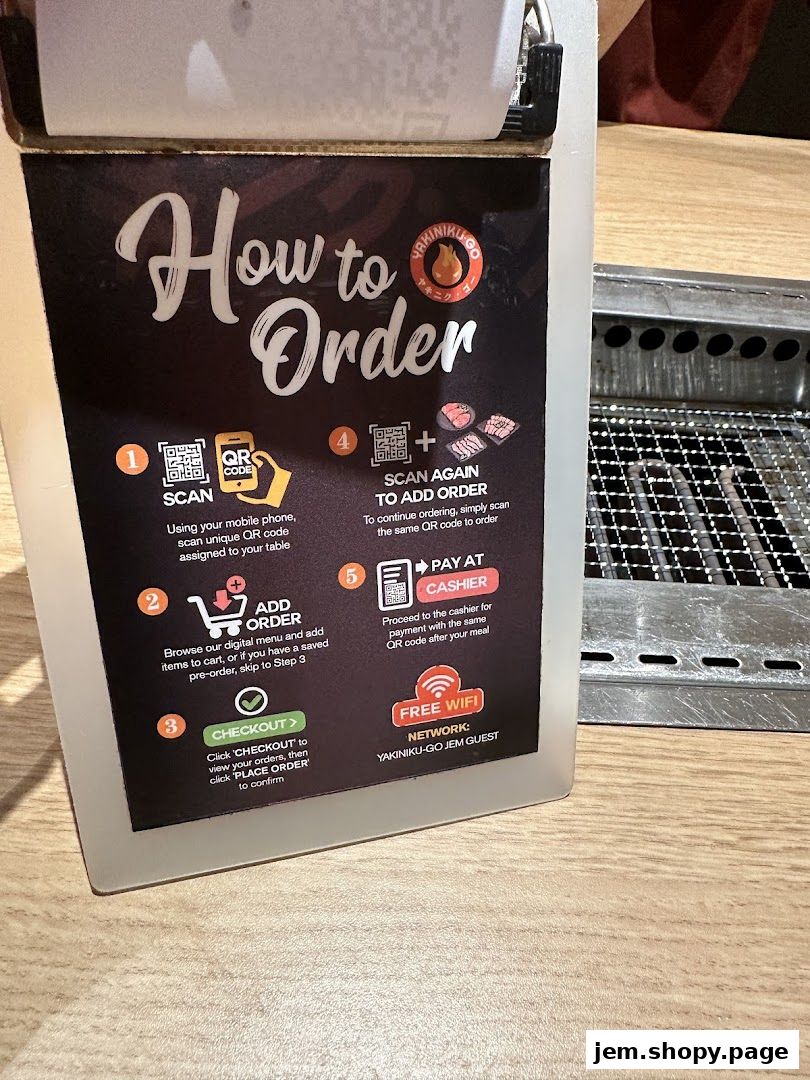 A sign explaining how to order at Yakiniku-GO JEM, with steps and QR codes.