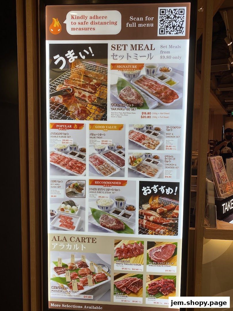 A menu board displaying various set meals and a la carte options for yakiniku.