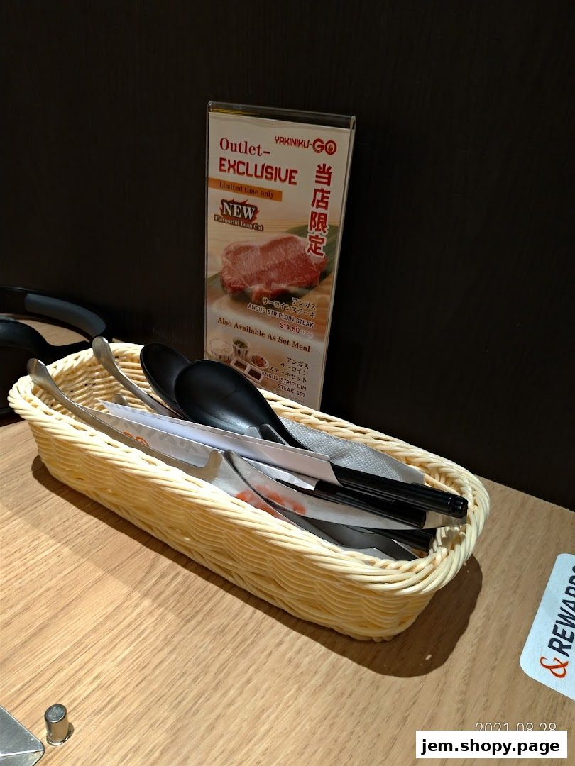 A basket of cutlery and a menu for Yakiniku-GO featuring an exclusive steak offer.