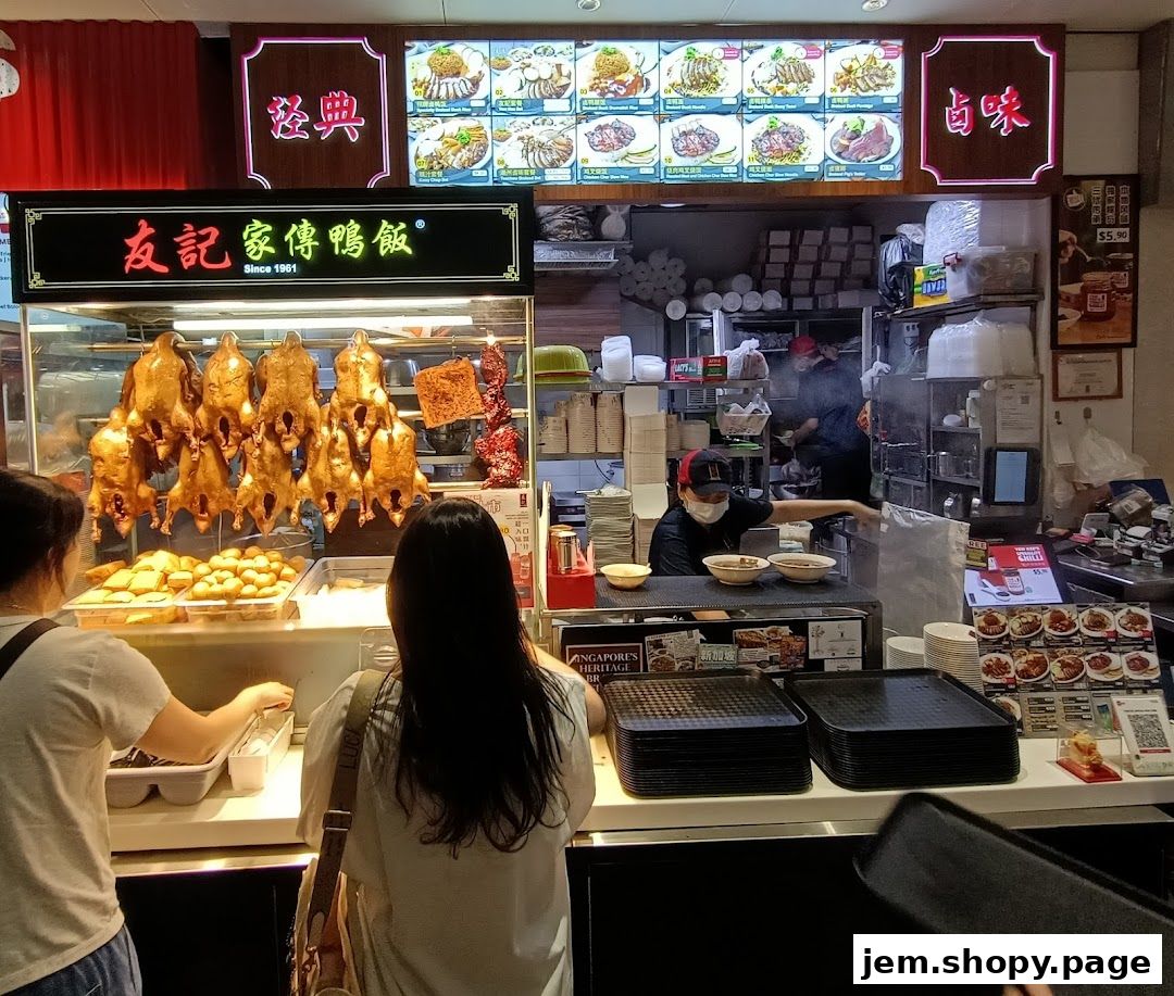 A food stall displaying roasted ducks and various dishes, with customers ordering.
