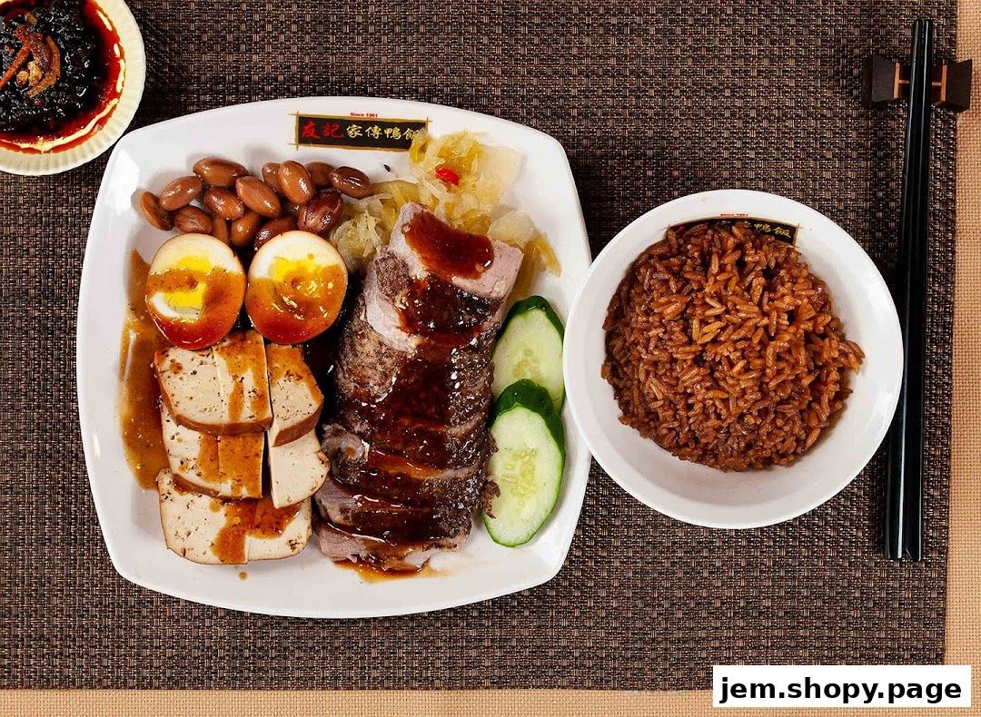 A plate of braised duck rice with braised eggs, tofu, peanuts, and pickled vegetables.