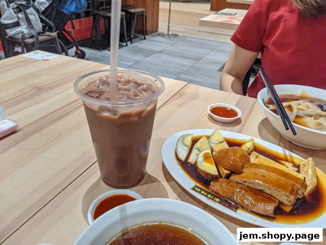 A table at Yew Kee Specialities with a chocolate drink and braised dishes.