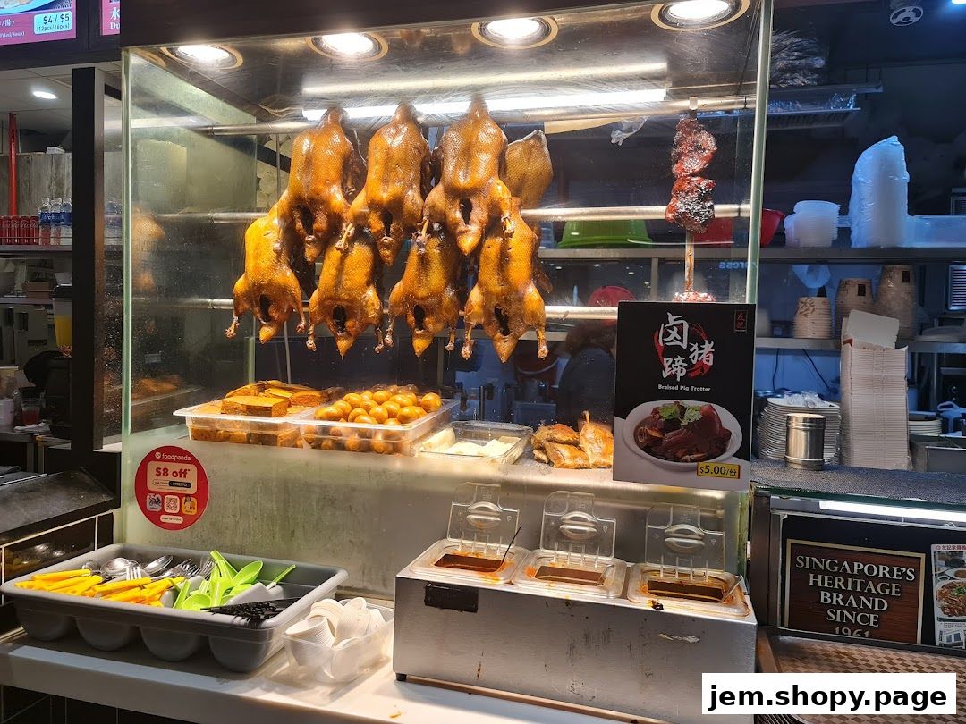A display of roasted ducks and braised pig trotters at a food stall.