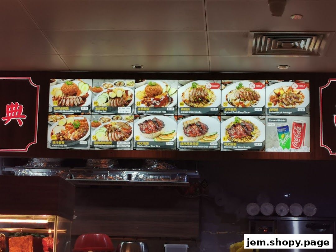 A digital menu board displaying various braised duck and chicken dishes with prices.