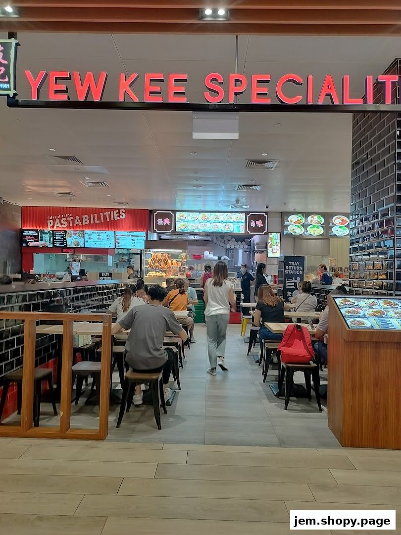 Interior view of Yew Kee Specialities restaurant with diners and food displays.