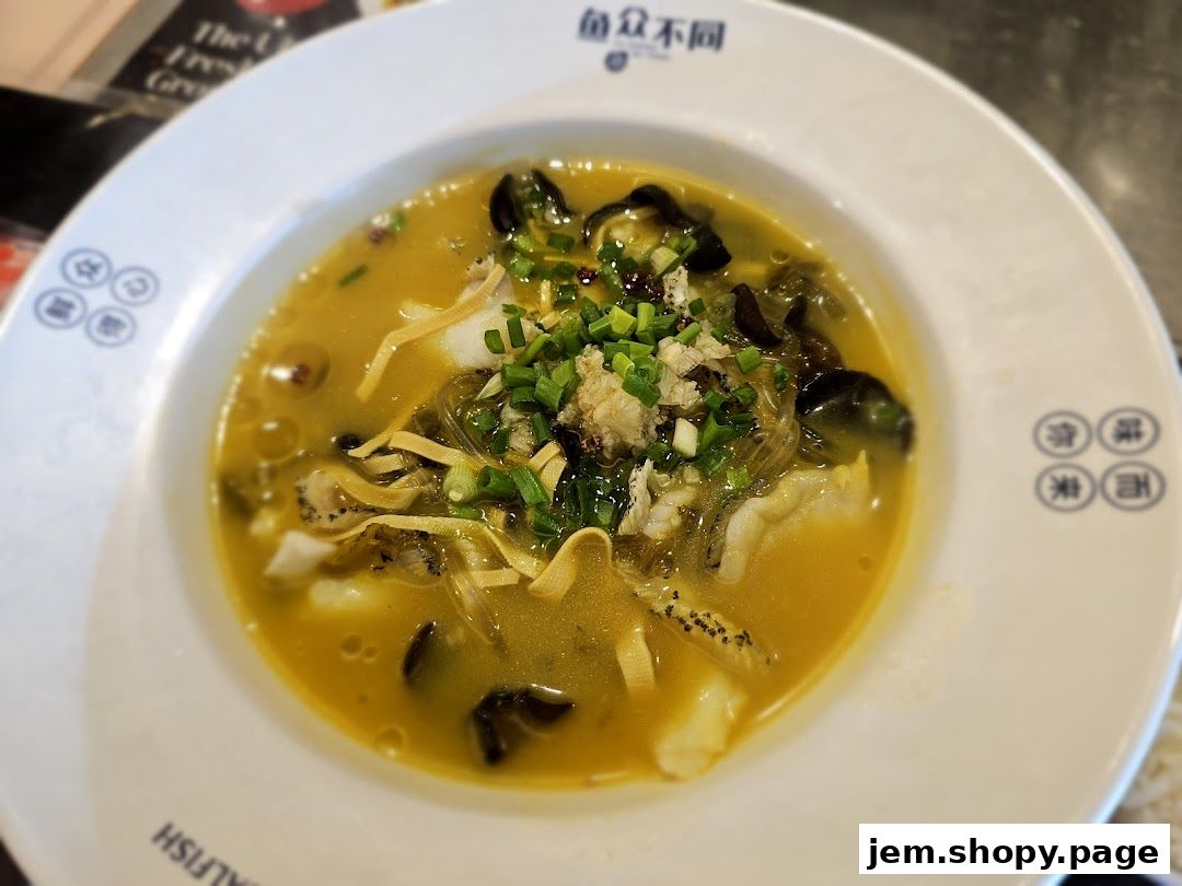 A close-up of a delicious fish soup dish with fresh ingredients and garnishes.