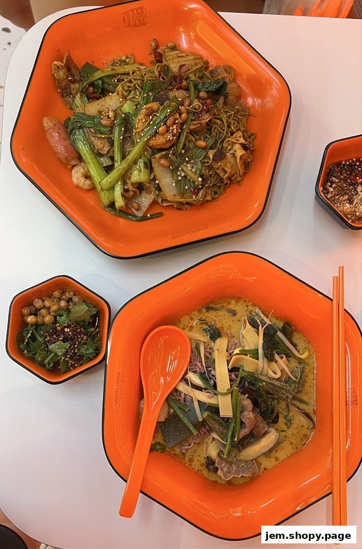 Two bowls of malatang, one dry and one soup-based, with side dishes.