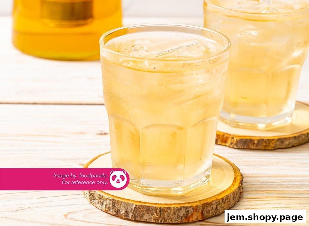 Two glasses of iced tea with a teapot in the background.