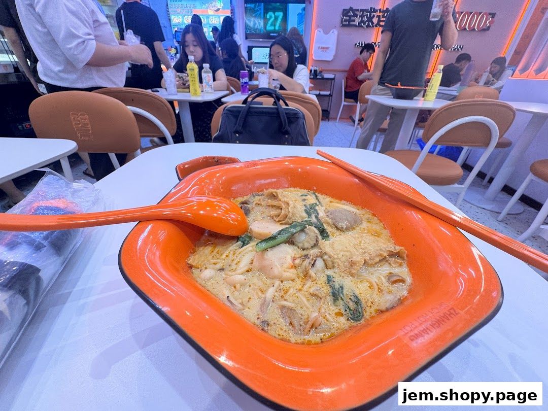 A close-up of a bowl of Malatang with chopsticks and a spoon on a table.