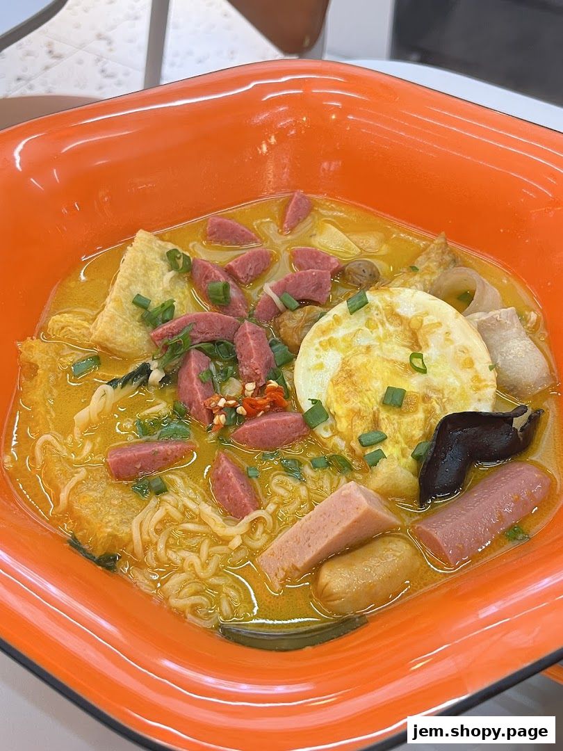 A close-up of a bowl of Malatang with noodles, sausages, egg, and vegetables.