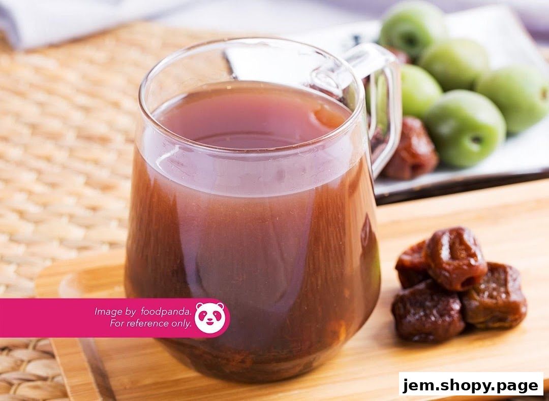 A refreshing glass of plum juice with dried plums and green plums.
