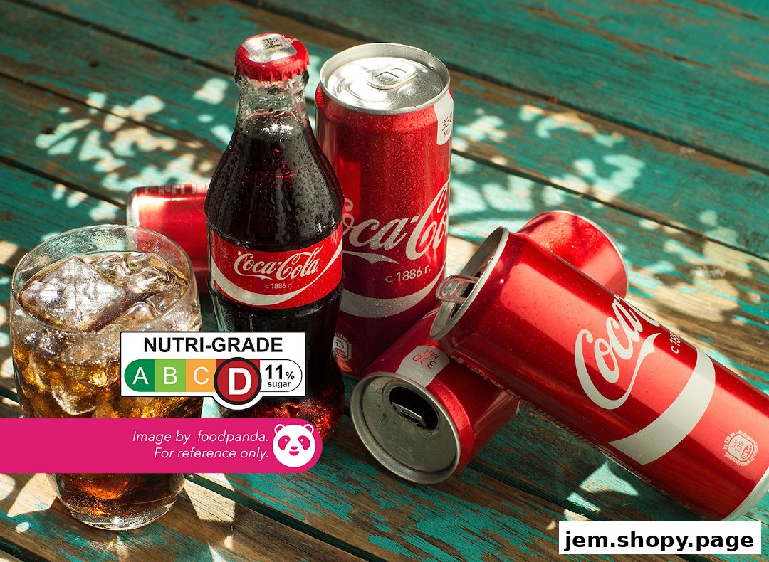 Coca-Cola products including a glass, bottle, and cans on a wooden surface.