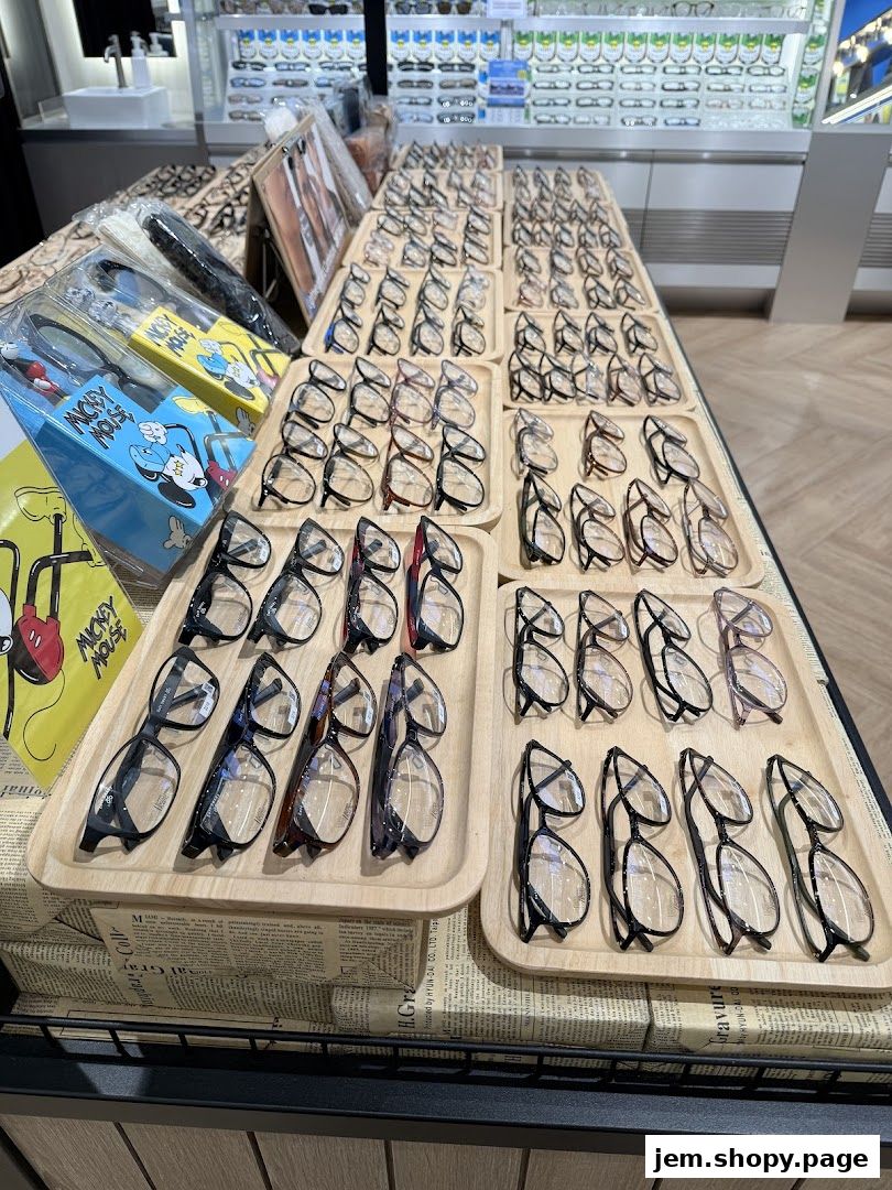 A display of various eyeglasses arranged on trays in a retail store.